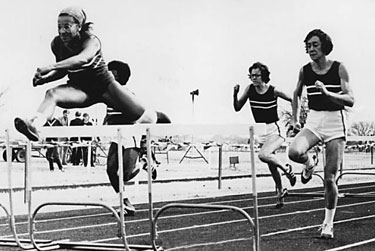 Athletes in hurdle race, track and field competition